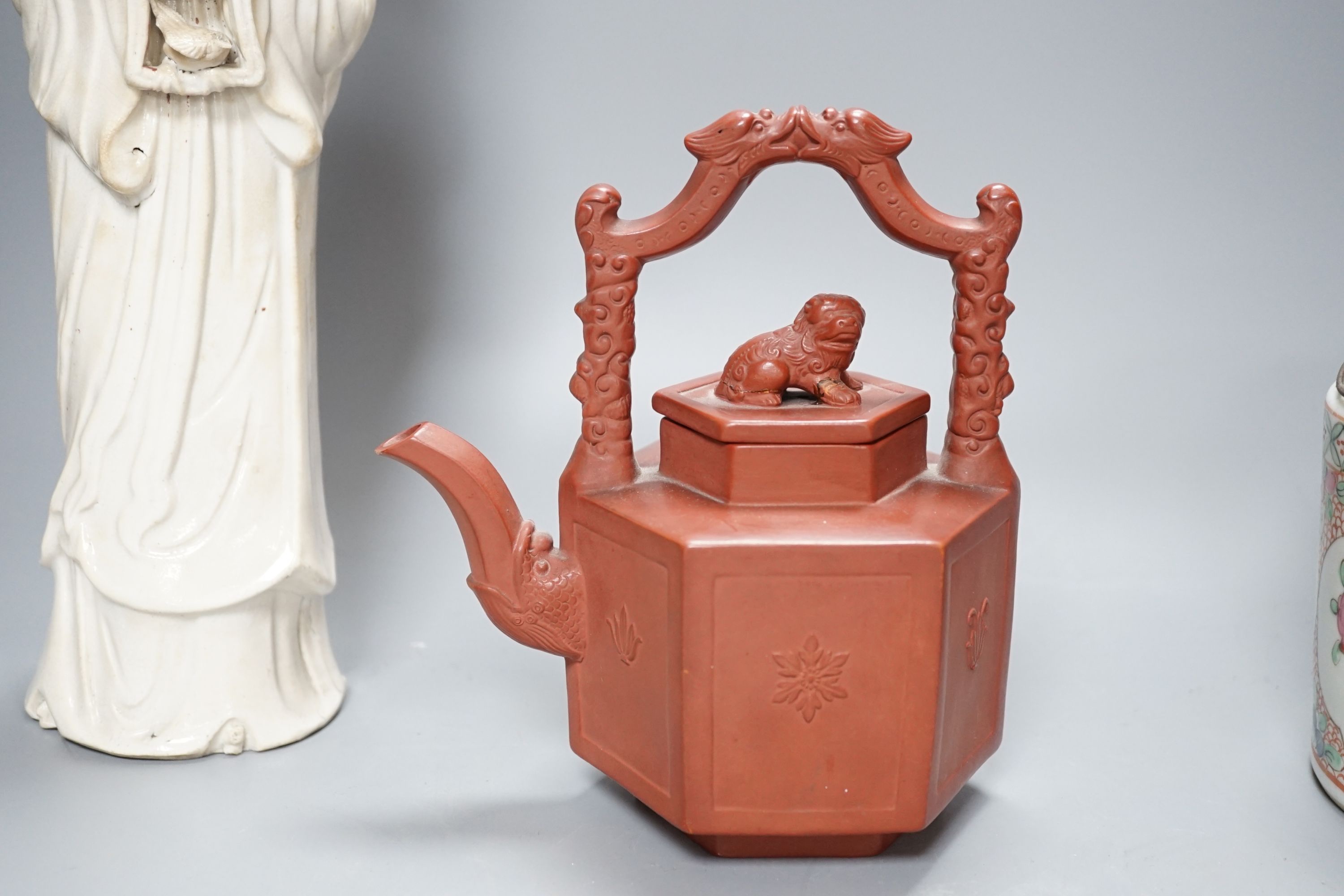 A Chinese blanc de chin figure of a lady with a bird, 37cm, together with a famille rose teapot, a yixing style teapot, blue and white jar and cover and a pale celadon ground ‘ox head’ libation cup
